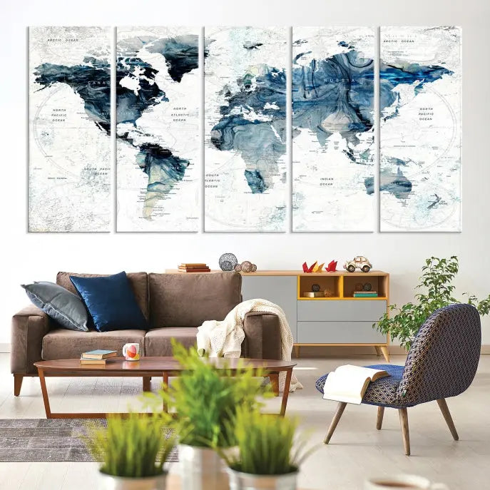 The Watercolor World Map Wall Art Canvas Print, a three-panel abstract masterpiece on museum-quality canvases, adorns the wall.