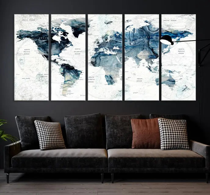 The Watercolor World Map Wall Art Canvas Print, a three-panel abstract masterpiece on museum-quality canvases, adorns the wall.