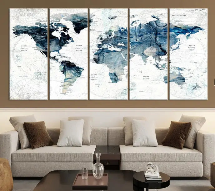 The Watercolor World Map Wall Art Canvas Print, a three-panel abstract masterpiece on museum-quality canvases, adorns the wall.