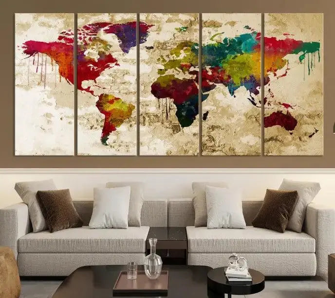 The modern living room features the Watercolor World Map Wall Art Canvas Print adorning the wall. The museum-quality canvas ensures every detail pops and is expertly crafted by professional craftsmen for a polished look that's ready to hang.