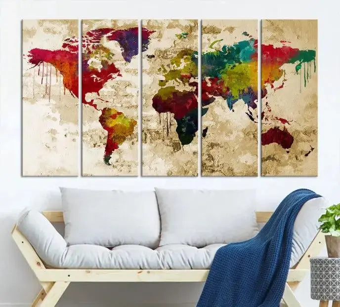 The modern living room features the Watercolor World Map Wall Art Canvas Print adorning the wall. The museum-quality canvas ensures every detail pops and is expertly crafted by professional craftsmen for a polished look that's ready to hang.
