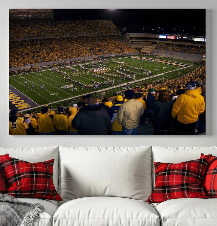 The living room is adorned with the West Virginia Uni Mountaineers Football Team Print, showcasing a captivating scene at Milan Puskar Stadium. This museum-quality, high-resolution canvas print adds a dynamic touch to the space.