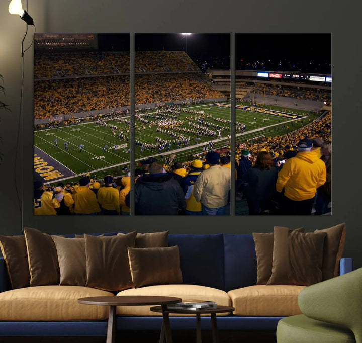 The living room is adorned with the West Virginia Uni Mountaineers Football Team Print, showcasing a captivating scene at Milan Puskar Stadium. This museum-quality, high-resolution canvas print adds a dynamic touch to the space.