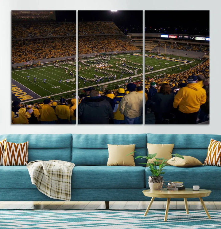 The living room is adorned with the West Virginia Uni Mountaineers Football Team Print, showcasing a captivating scene at Milan Puskar Stadium. This museum-quality, high-resolution canvas print adds a dynamic touch to the space.