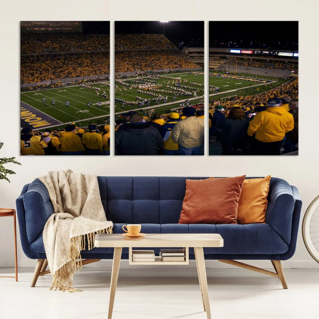 The living room is adorned with the West Virginia Uni Mountaineers Football Team Print, showcasing a captivating scene at Milan Puskar Stadium. This museum-quality, high-resolution canvas print adds a dynamic touch to the space.