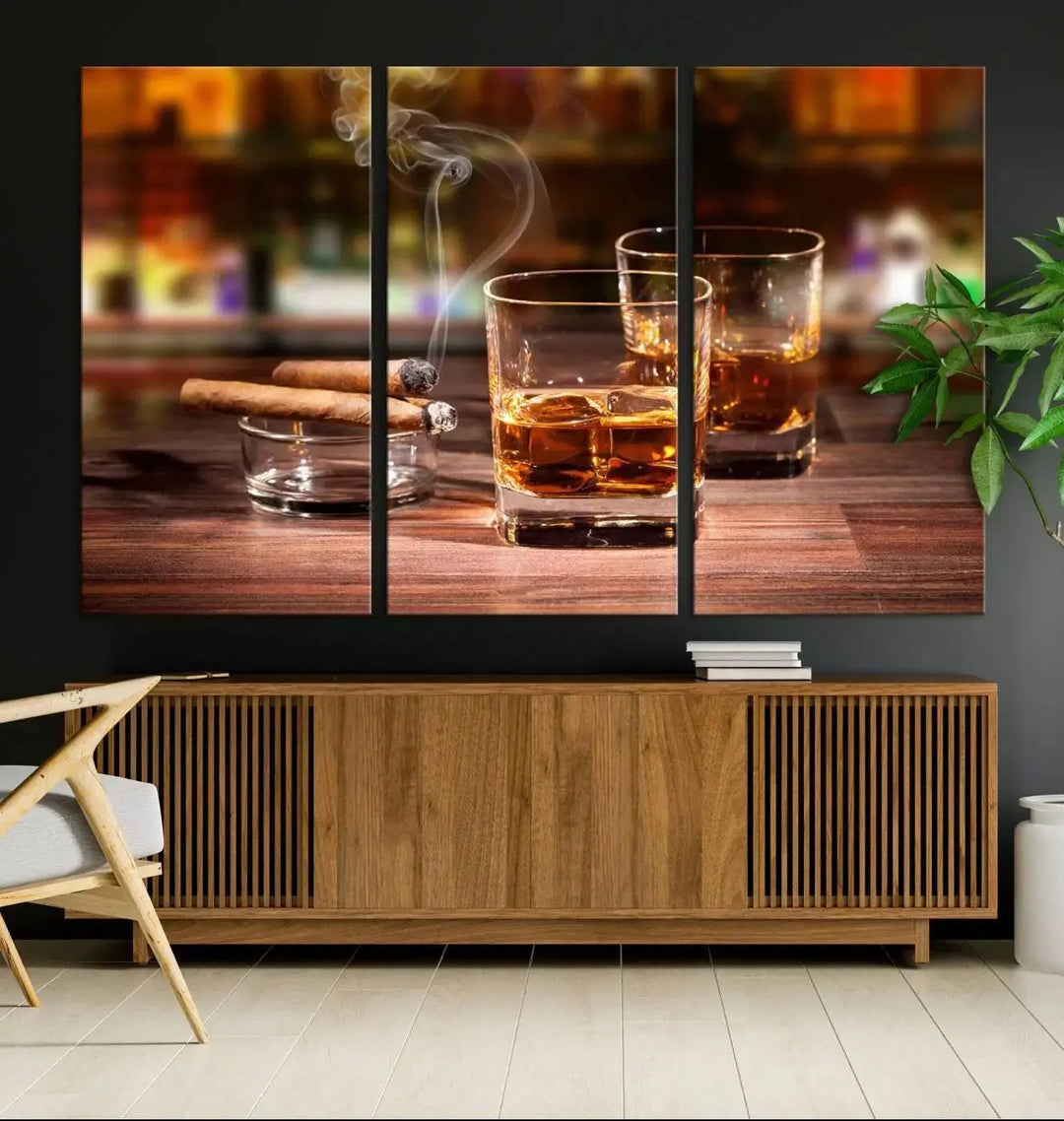 The Whiskey Cuban Cigars Canvas Print is a triptych wall art set that showcases two cigars and whiskey glasses on a wooden table. It is printed on museum-quality canvases with a UV-protective coating, designed for easy hanging.