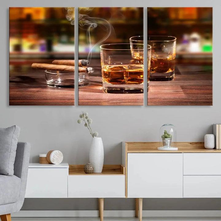 The Whiskey Cuban Cigars Canvas Print is a triptych wall art set that showcases two cigars and whiskey glasses on a wooden table. It is printed on museum-quality canvases with a UV-protective coating, designed for easy hanging.