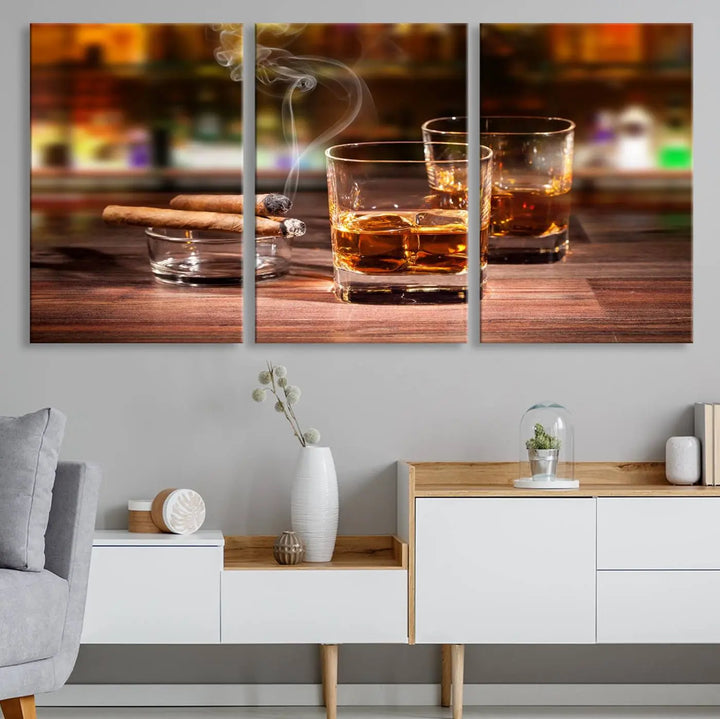 The Whiskey Cuban Cigars Canvas Print is a triptych wall art set that showcases two cigars and whiskey glasses on a wooden table. It is printed on museum-quality canvases with a UV-protective coating, designed for easy hanging.