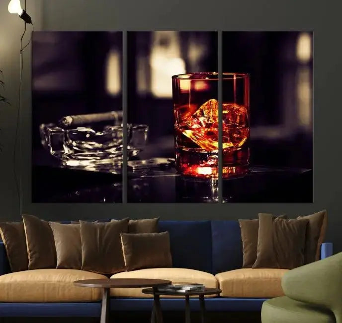 The Whiskey and Cigar Canvas, a luxurious triptych wall art for your living room or bar, portrays a whiskey glass and cigar on a table. This artwork beautifully captures the essence of opulent home decor.