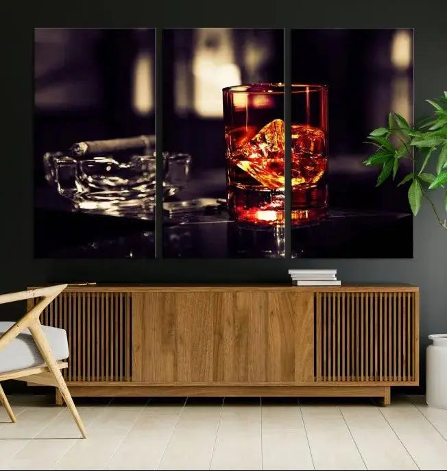 The Whiskey and Cigar Canvas, a luxurious triptych wall art for your living room or bar, portrays a whiskey glass and cigar on a table. This artwork beautifully captures the essence of opulent home decor.