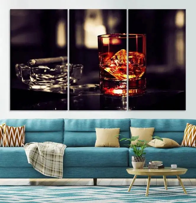 The Whiskey and Cigar Canvas, a luxurious triptych wall art for your living room or bar, portrays a whiskey glass and cigar on a table. This artwork beautifully captures the essence of opulent home decor.