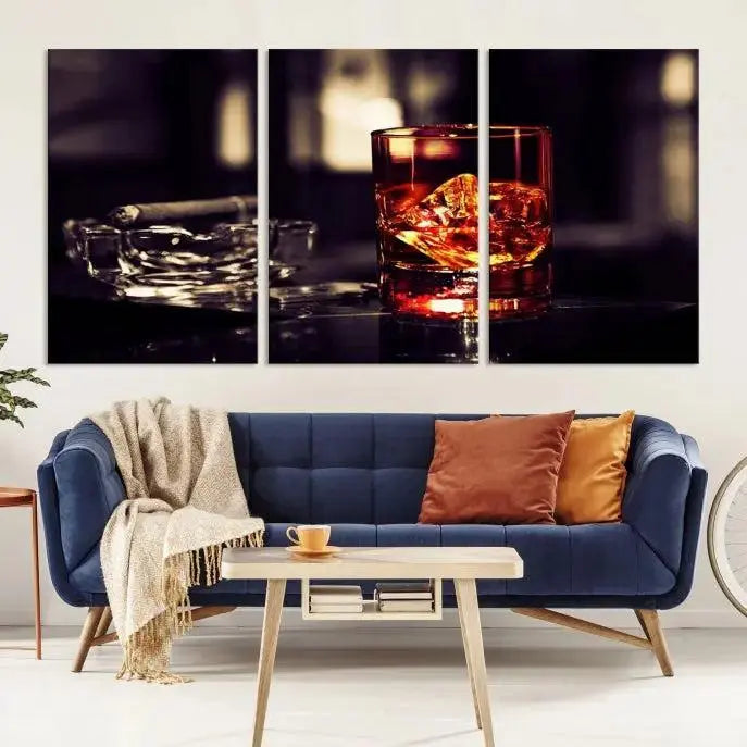 The Whiskey and Cigar Canvas, a luxurious triptych wall art for your living room or bar, portrays a whiskey glass and cigar on a table. This artwork beautifully captures the essence of opulent home decor.