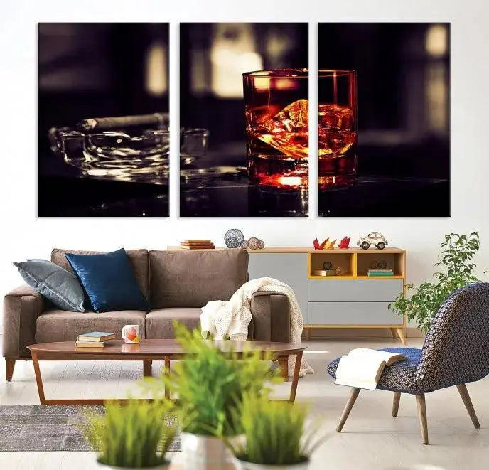 The Whiskey and Cigar Canvas, a luxurious triptych wall art for your living room or bar, portrays a whiskey glass and cigar on a table. This artwork beautifully captures the essence of opulent home decor.