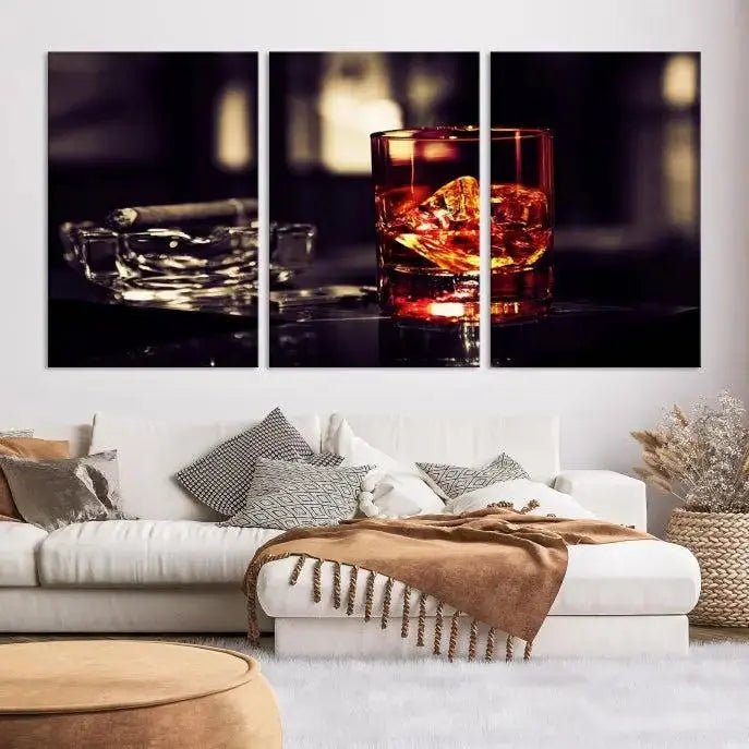 The Whiskey and Cigar Canvas, a luxurious triptych wall art for your living room or bar, portrays a whiskey glass and cigar on a table. This artwork beautifully captures the essence of opulent home decor.