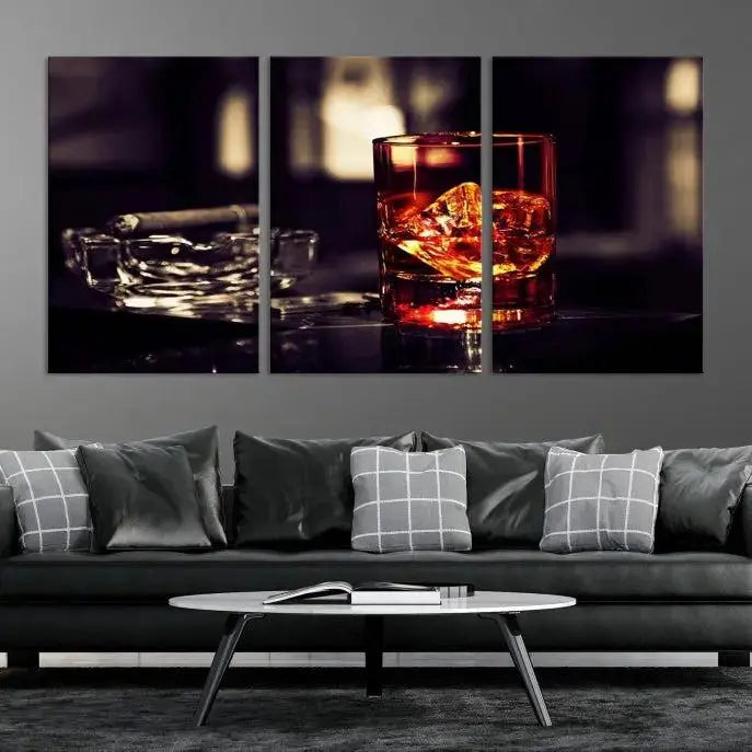 The Whiskey and Cigar Canvas, a luxurious triptych wall art for your living room or bar, portrays a whiskey glass and cigar on a table. This artwork beautifully captures the essence of opulent home decor.