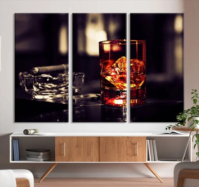 The Whiskey and Cigar Canvas, a luxurious triptych wall art for your living room or bar, portrays a whiskey glass and cigar on a table. This artwork beautifully captures the essence of opulent home decor.