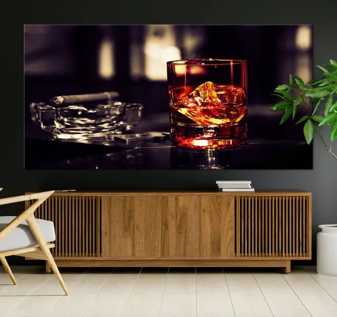 The Whiskey and Cigar Canvas, a luxurious triptych wall art for your living room or bar, portrays a whiskey glass and cigar on a table. This artwork beautifully captures the essence of opulent home decor.