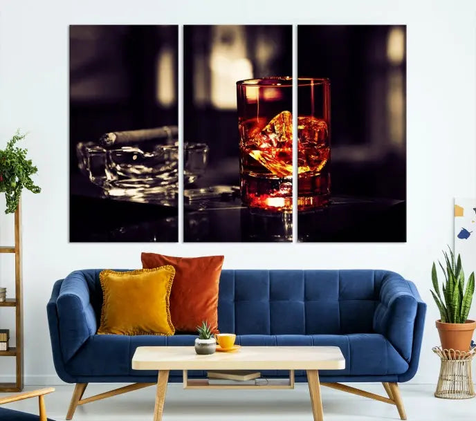 The Whiskey and Cigar Canvas, a luxurious triptych wall art for your living room or bar, portrays a whiskey glass and cigar on a table. This artwork beautifully captures the essence of opulent home decor.