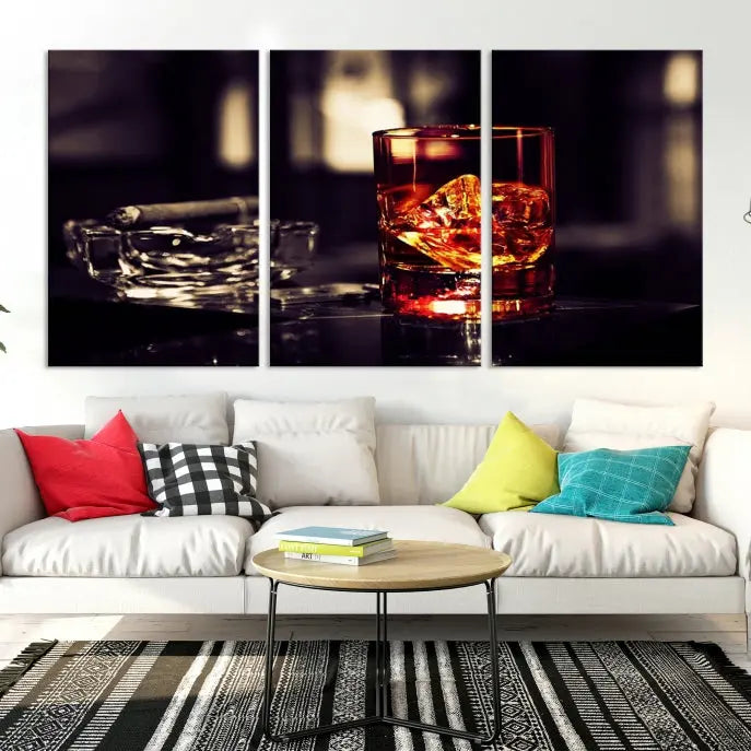 The Whiskey and Cigar Canvas, a luxurious triptych wall art for your living room or bar, portrays a whiskey glass and cigar on a table. This artwork beautifully captures the essence of opulent home decor.