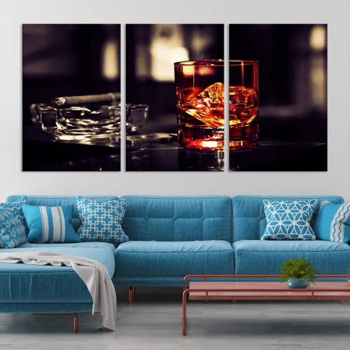 The Whiskey and Cigar Canvas, a luxurious triptych wall art for your living room or bar, portrays a whiskey glass and cigar on a table. This artwork beautifully captures the essence of opulent home decor.