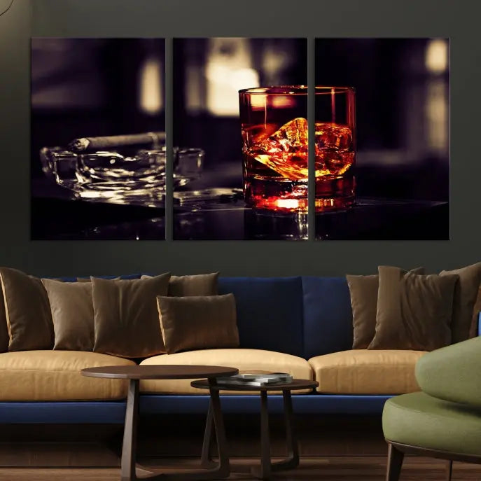 The Whiskey and Cigar Canvas, a luxurious triptych wall art for your living room or bar, portrays a whiskey glass and cigar on a table. This artwork beautifully captures the essence of opulent home decor.