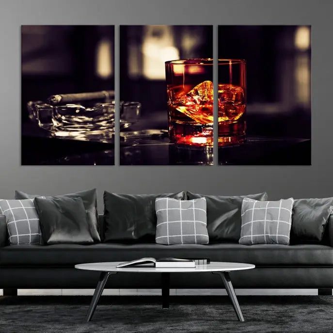 The Whiskey and Cigar Canvas, a luxurious triptych wall art for your living room or bar, portrays a whiskey glass and cigar on a table. This artwork beautifully captures the essence of opulent home decor.