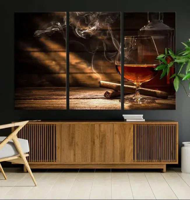 Whiskey and Cigar Wall Art Canvas Print showcases a glass of brandy, a lit cigar, and swirling smoke. This museum-quality canvas is ready to hang and features a UV-protective coating for enduring vibrancy.