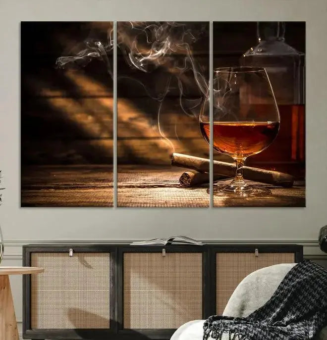 Whiskey and Cigar Wall Art Canvas Print showcases a glass of brandy, a lit cigar, and swirling smoke. This museum-quality canvas is ready to hang and features a UV-protective coating for enduring vibrancy.