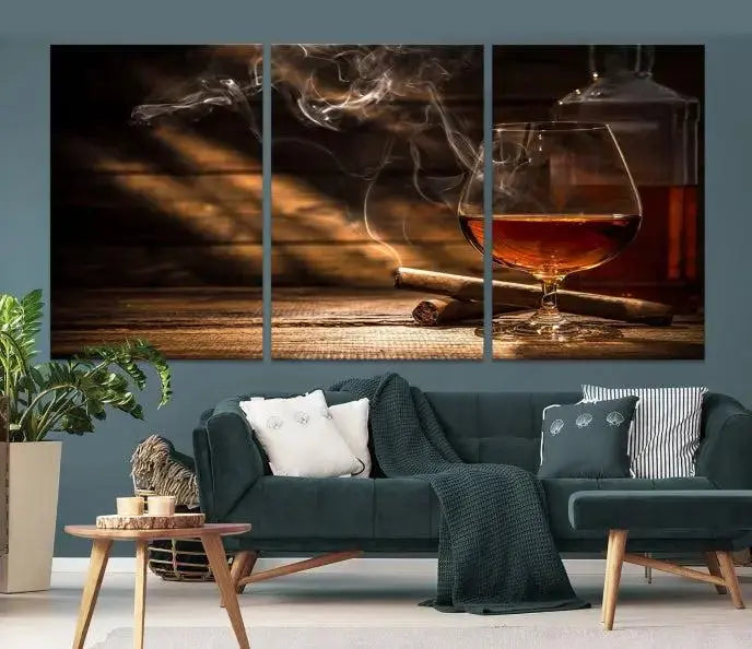 Whiskey and Cigar Wall Art Canvas Print showcases a glass of brandy, a lit cigar, and swirling smoke. This museum-quality canvas is ready to hang and features a UV-protective coating for enduring vibrancy.