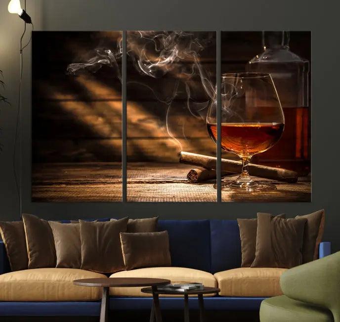 Whiskey and Cigar Wall Art Canvas Print showcases a glass of brandy, a lit cigar, and swirling smoke. This museum-quality canvas is ready to hang and features a UV-protective coating for enduring vibrancy.