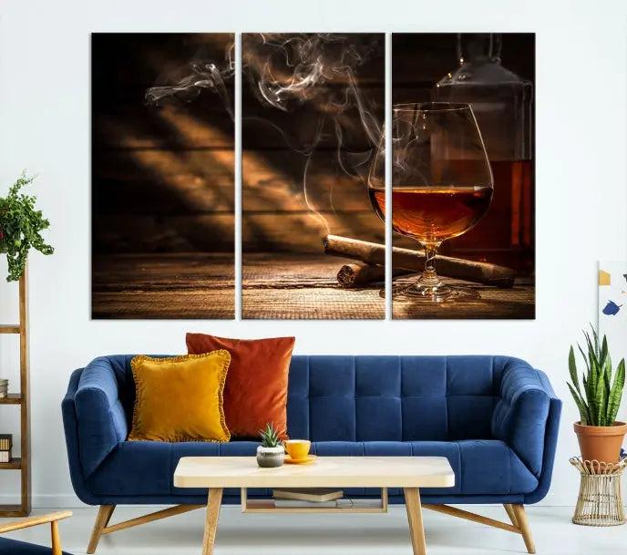 Whiskey and Cigar Wall Art Canvas Print showcases a glass of brandy, a lit cigar, and swirling smoke. This museum-quality canvas is ready to hang and features a UV-protective coating for enduring vibrancy.