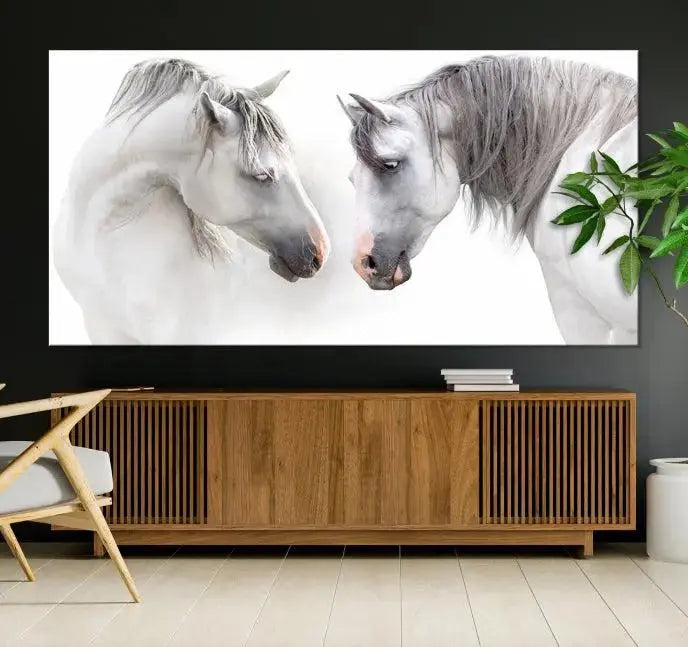 The "White Horse Wall Art Animal Canvas Print," featuring two white horses facing each other, is elegantly displayed. This triptych is gallery wrapped on museum-quality canvas, ensuring long-lasting beauty and sophistication.