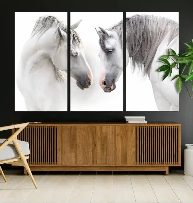 The "White Horse Wall Art Animal Canvas Print," featuring two white horses facing each other, is elegantly displayed. This triptych is gallery wrapped on museum-quality canvas, ensuring long-lasting beauty and sophistication.