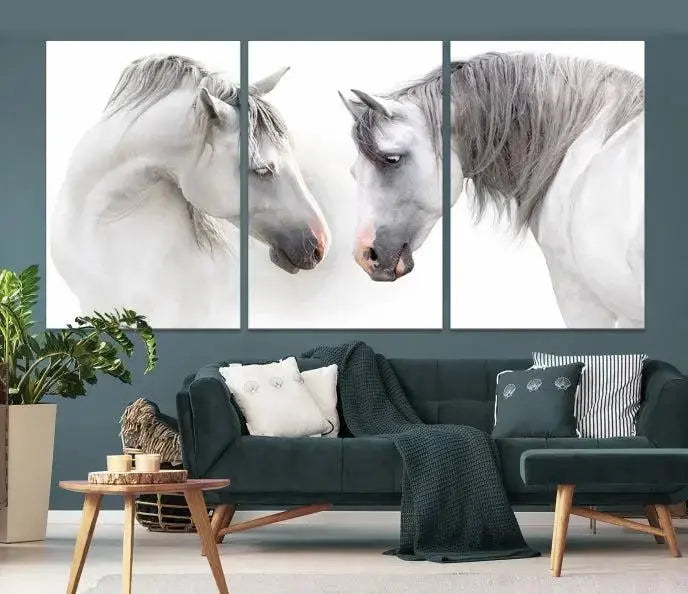 The "White Horse Wall Art Animal Canvas Print," featuring two white horses facing each other, is elegantly displayed. This triptych is gallery wrapped on museum-quality canvas, ensuring long-lasting beauty and sophistication.