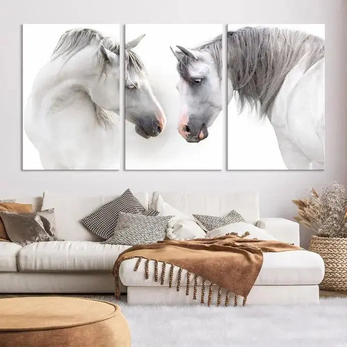 The "White Horse Wall Art Animal Canvas Print," featuring two white horses facing each other, is elegantly displayed. This triptych is gallery wrapped on museum-quality canvas, ensuring long-lasting beauty and sophistication.