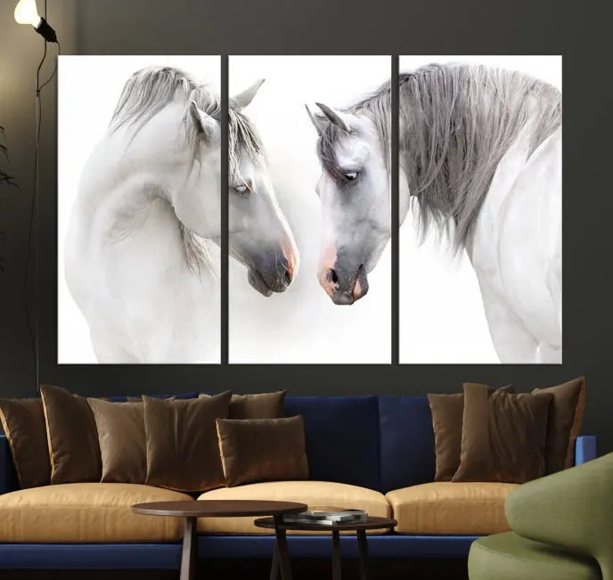 The "White Horse Wall Art Animal Canvas Print," featuring two white horses facing each other, is elegantly displayed. This triptych is gallery wrapped on museum-quality canvas, ensuring long-lasting beauty and sophistication.