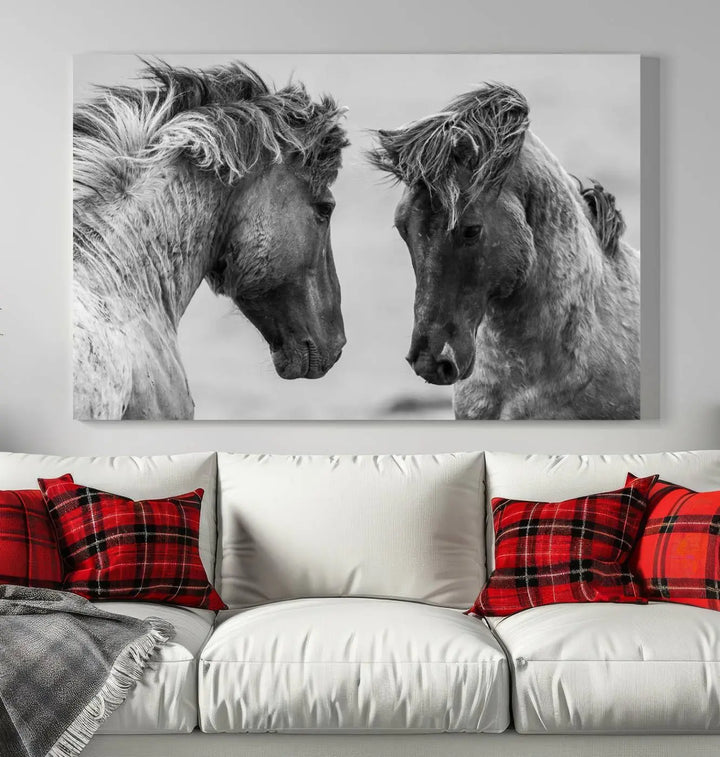 The "White Horses Wall Art Canvas Print" features a striking black and white triptych of two horses facing each other, perfect for display on a dark wall. Each piece is crafted on museum-quality poly-cotton canvas and meticulously hand-assembled, ensuring both elegance and long-lasting durability. Elevate your space effortlessly with free shipping included.