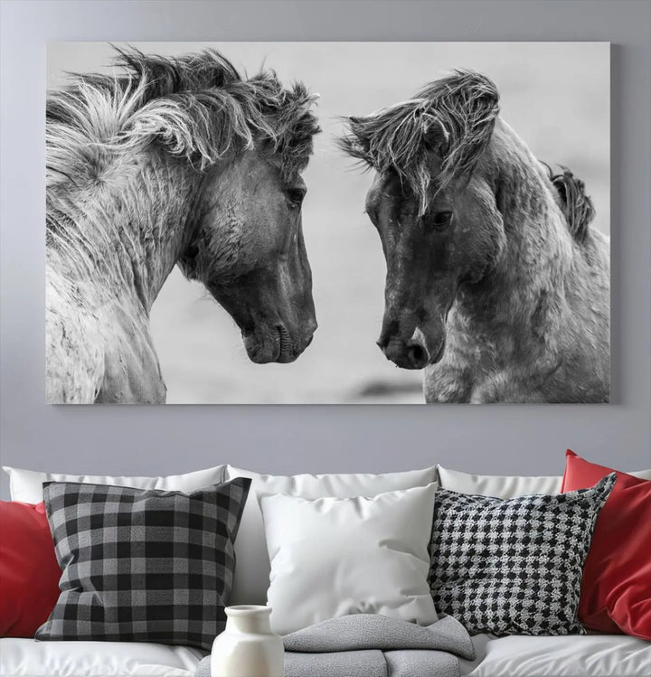 The "White Horses Wall Art Canvas Print" features a striking black and white triptych of two horses facing each other, perfect for display on a dark wall. Each piece is crafted on museum-quality poly-cotton canvas and meticulously hand-assembled, ensuring both elegance and long-lasting durability. Elevate your space effortlessly with free shipping included.