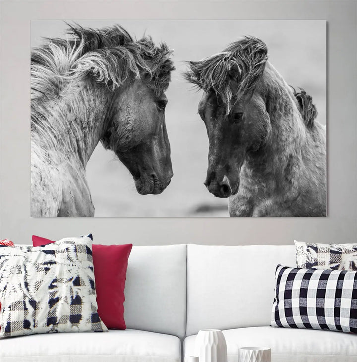 The "White Horses Wall Art Canvas Print" features a striking black and white triptych of two horses facing each other, perfect for display on a dark wall. Each piece is crafted on museum-quality poly-cotton canvas and meticulously hand-assembled, ensuring both elegance and long-lasting durability. Elevate your space effortlessly with free shipping included.