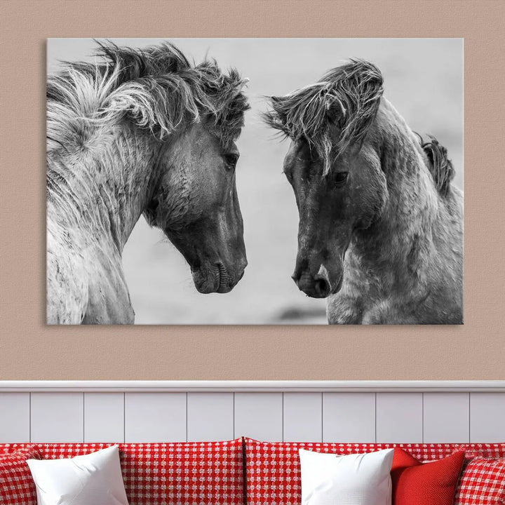 The "White Horses Wall Art Canvas Print" features a striking black and white triptych of two horses facing each other, perfect for display on a dark wall. Each piece is crafted on museum-quality poly-cotton canvas and meticulously hand-assembled, ensuring both elegance and long-lasting durability. Elevate your space effortlessly with free shipping included.