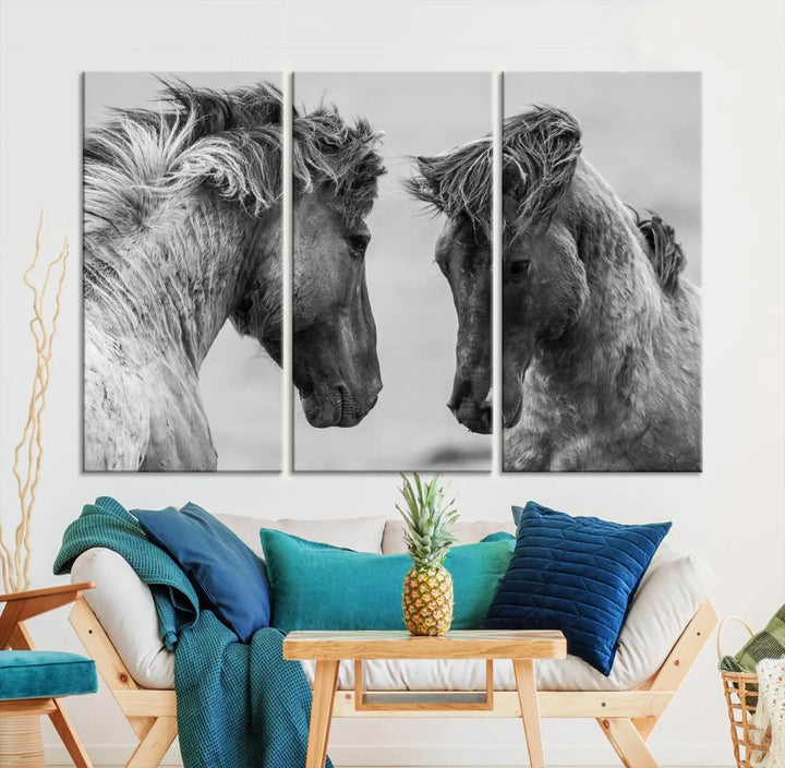 The "White Horses Wall Art Canvas Print" features a striking black and white triptych of two horses facing each other, perfect for display on a dark wall. Each piece is crafted on museum-quality poly-cotton canvas and meticulously hand-assembled, ensuring both elegance and long-lasting durability. Elevate your space effortlessly with free shipping included.