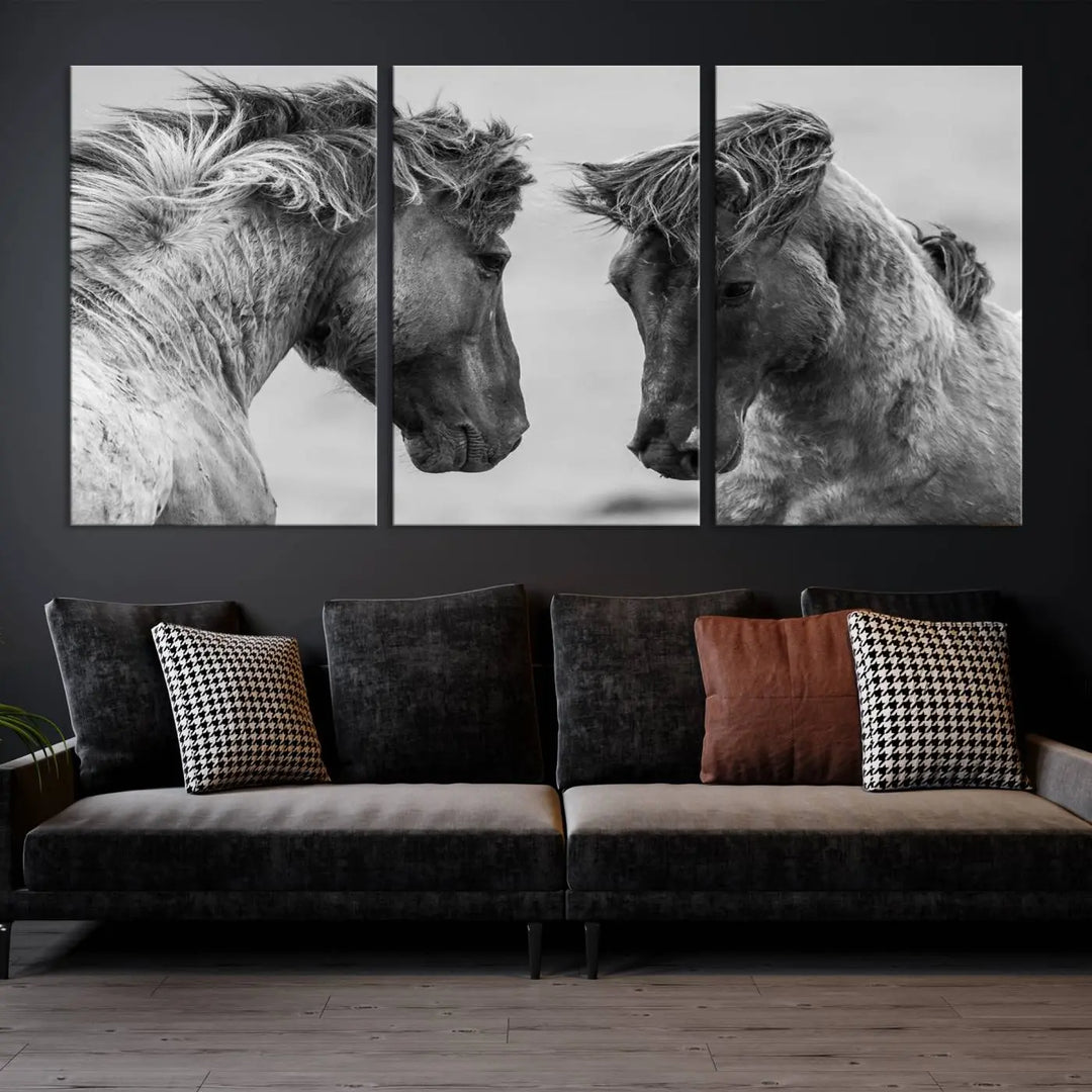 The "White Horses Wall Art Canvas Print" features a striking black and white triptych of two horses facing each other, perfect for display on a dark wall. Each piece is crafted on museum-quality poly-cotton canvas and meticulously hand-assembled, ensuring both elegance and long-lasting durability. Elevate your space effortlessly with free shipping included.