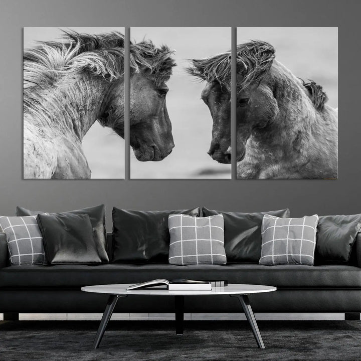 The "White Horses Wall Art Canvas Print" features a striking black and white triptych of two horses facing each other, perfect for display on a dark wall. Each piece is crafted on museum-quality poly-cotton canvas and meticulously hand-assembled, ensuring both elegance and long-lasting durability. Elevate your space effortlessly with free shipping included.