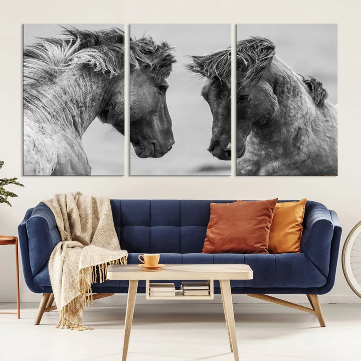 The "White Horses Wall Art Canvas Print" features a striking black and white triptych of two horses facing each other, perfect for display on a dark wall. Each piece is crafted on museum-quality poly-cotton canvas and meticulously hand-assembled, ensuring both elegance and long-lasting durability. Elevate your space effortlessly with free shipping included.