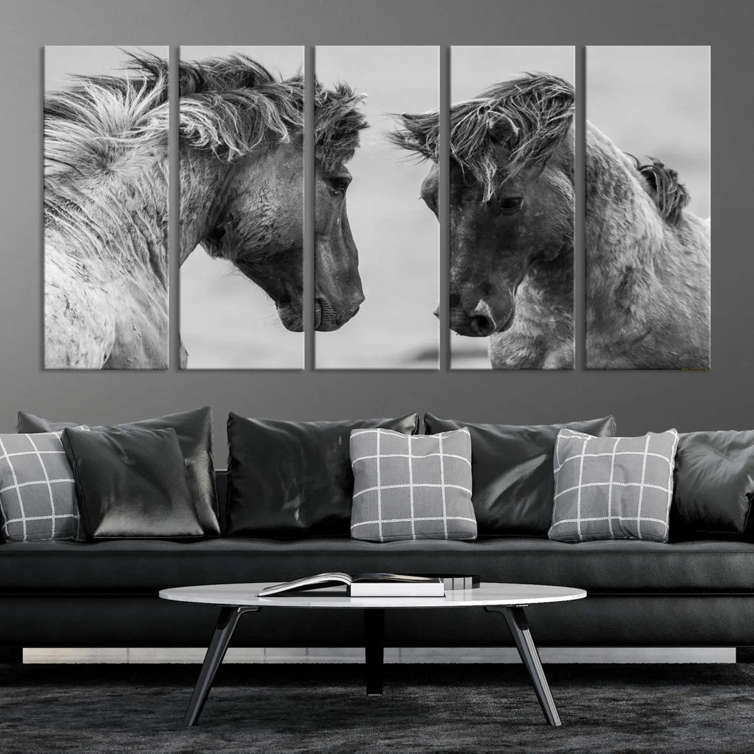 The "White Horses Wall Art Canvas Print" features a striking black and white triptych of two horses facing each other, perfect for display on a dark wall. Each piece is crafted on museum-quality poly-cotton canvas and meticulously hand-assembled, ensuring both elegance and long-lasting durability. Elevate your space effortlessly with free shipping included.