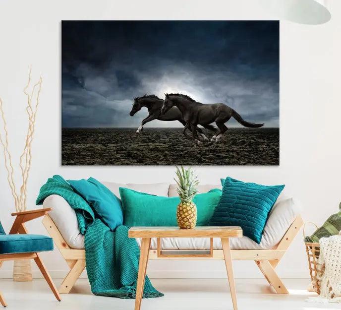 The Wild Horses Wall Art Canvas Print features a triptych of two galloping black horses set against a dark, cloudy landscape. This piece is gallery-wrapped on museum-quality canvas.