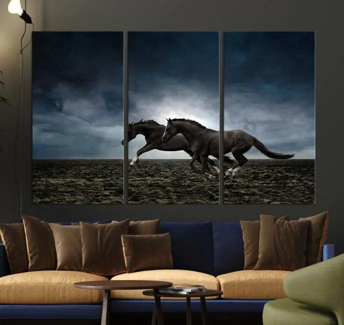 The Wild Horses Wall Art Canvas Print features a triptych of two galloping black horses set against a dark, cloudy landscape. This piece is gallery-wrapped on museum-quality canvas.