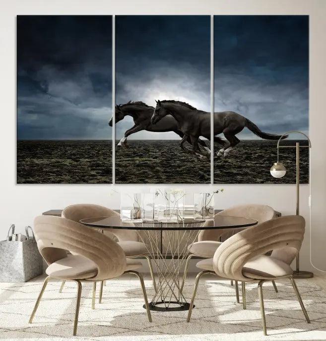 The Wild Horses Wall Art Canvas Print features a triptych of two galloping black horses set against a dark, cloudy landscape. This piece is gallery-wrapped on museum-quality canvas.