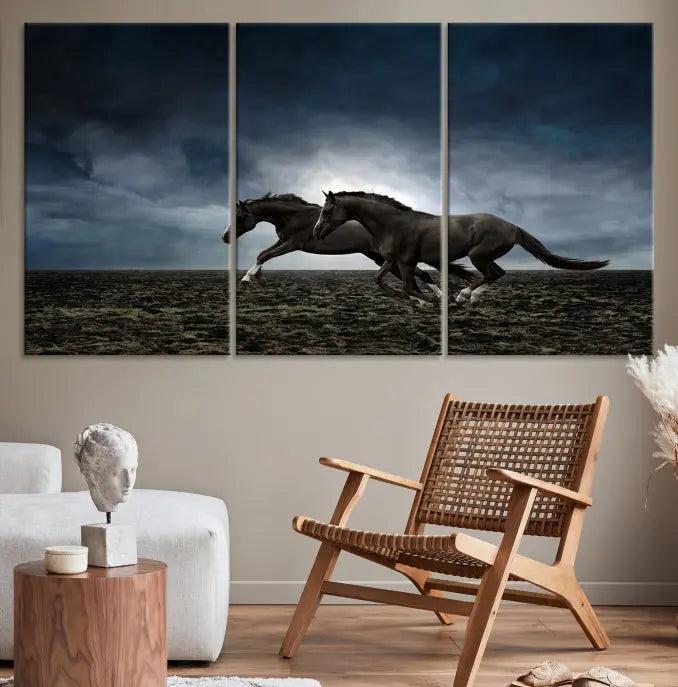 The Wild Horses Wall Art Canvas Print features a triptych of two galloping black horses set against a dark, cloudy landscape. This piece is gallery-wrapped on museum-quality canvas.