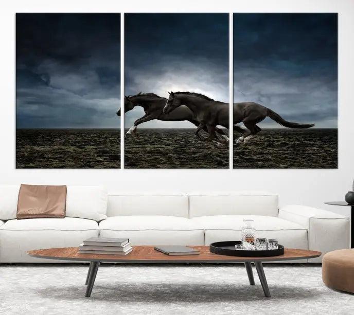 The Wild Horses Wall Art Canvas Print features a triptych of two galloping black horses set against a dark, cloudy landscape. This piece is gallery-wrapped on museum-quality canvas.